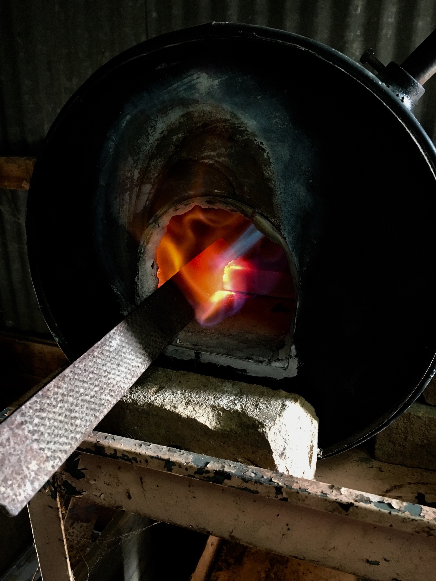 Blade being heat treated in a propane forge